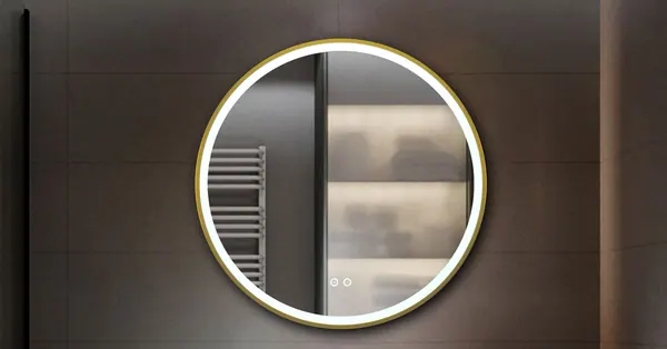 Round backlit Keliss mirror in a dark bathroom